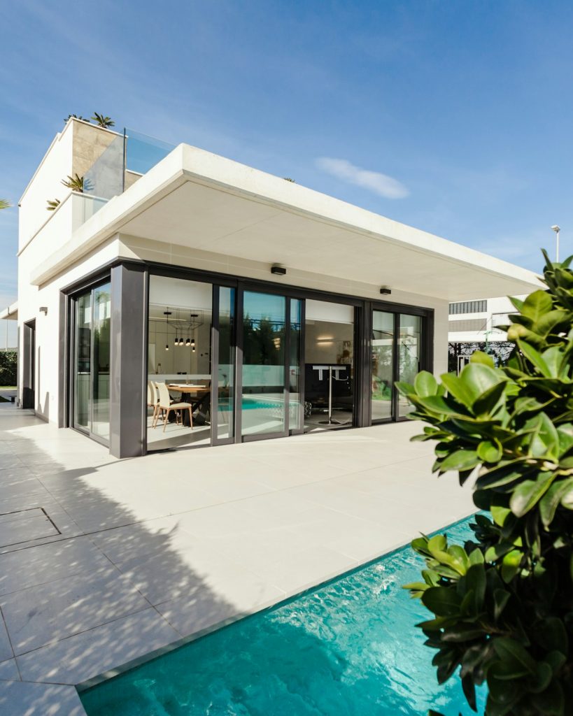 Grand modern estate with manicured front lawn